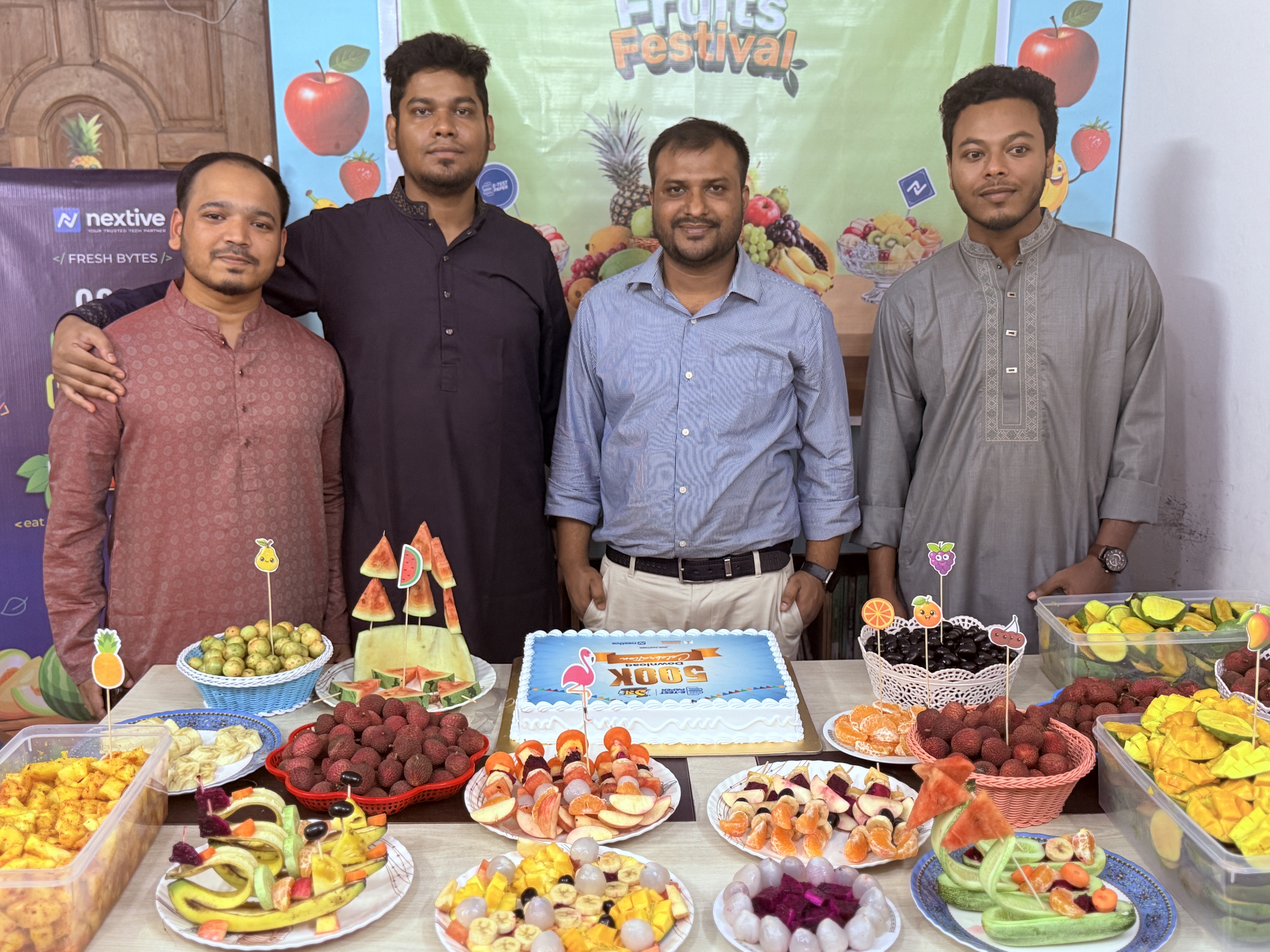 Team members with festive fruit spread and cake
