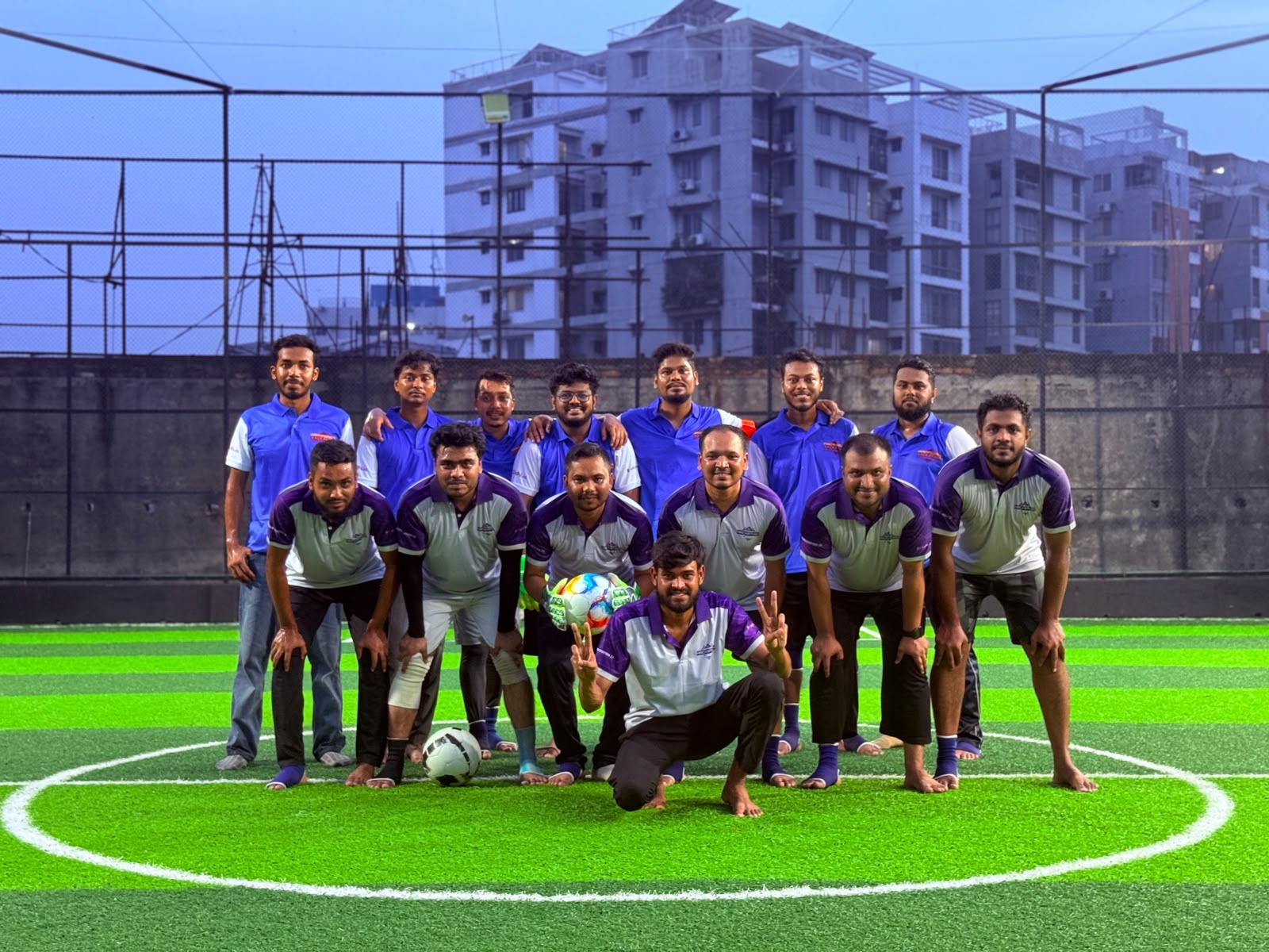 Full squad group photo on the pitch